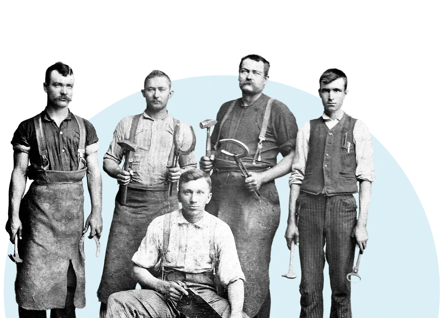 Eight workers in rugged clothes stand at a tunnel entrance with rail tracks