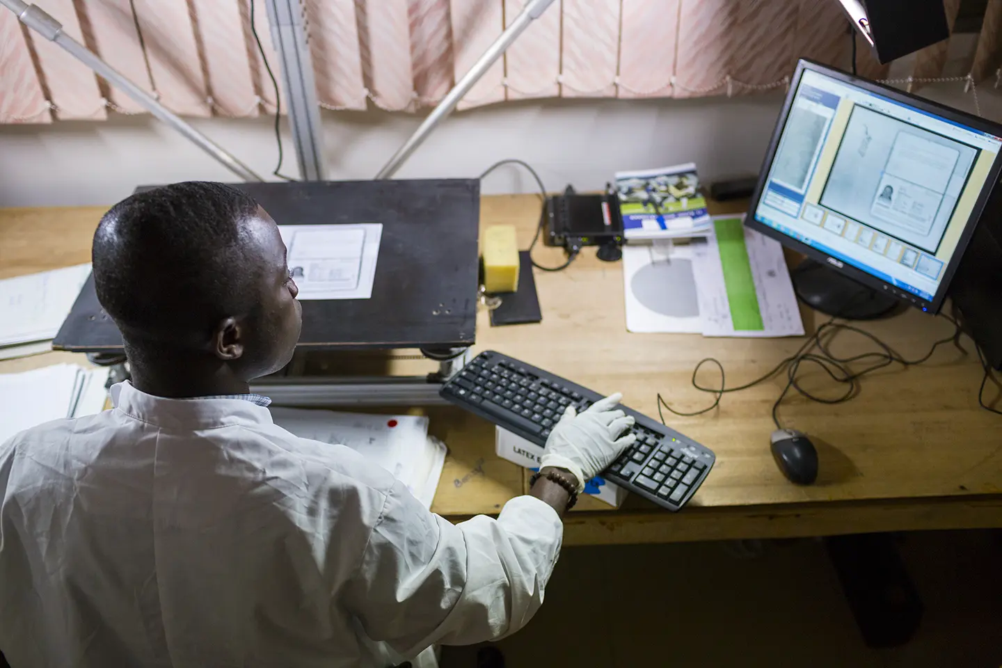 A man viewing a digital image of a historical record he just scanned.