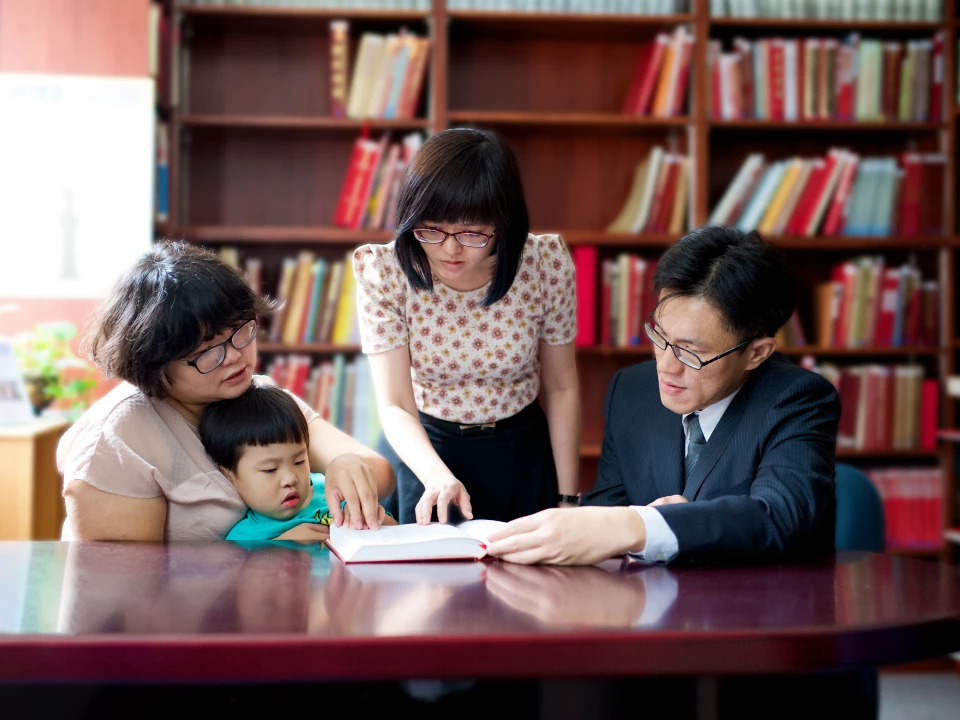 Asian family looking at books at an affiliate library